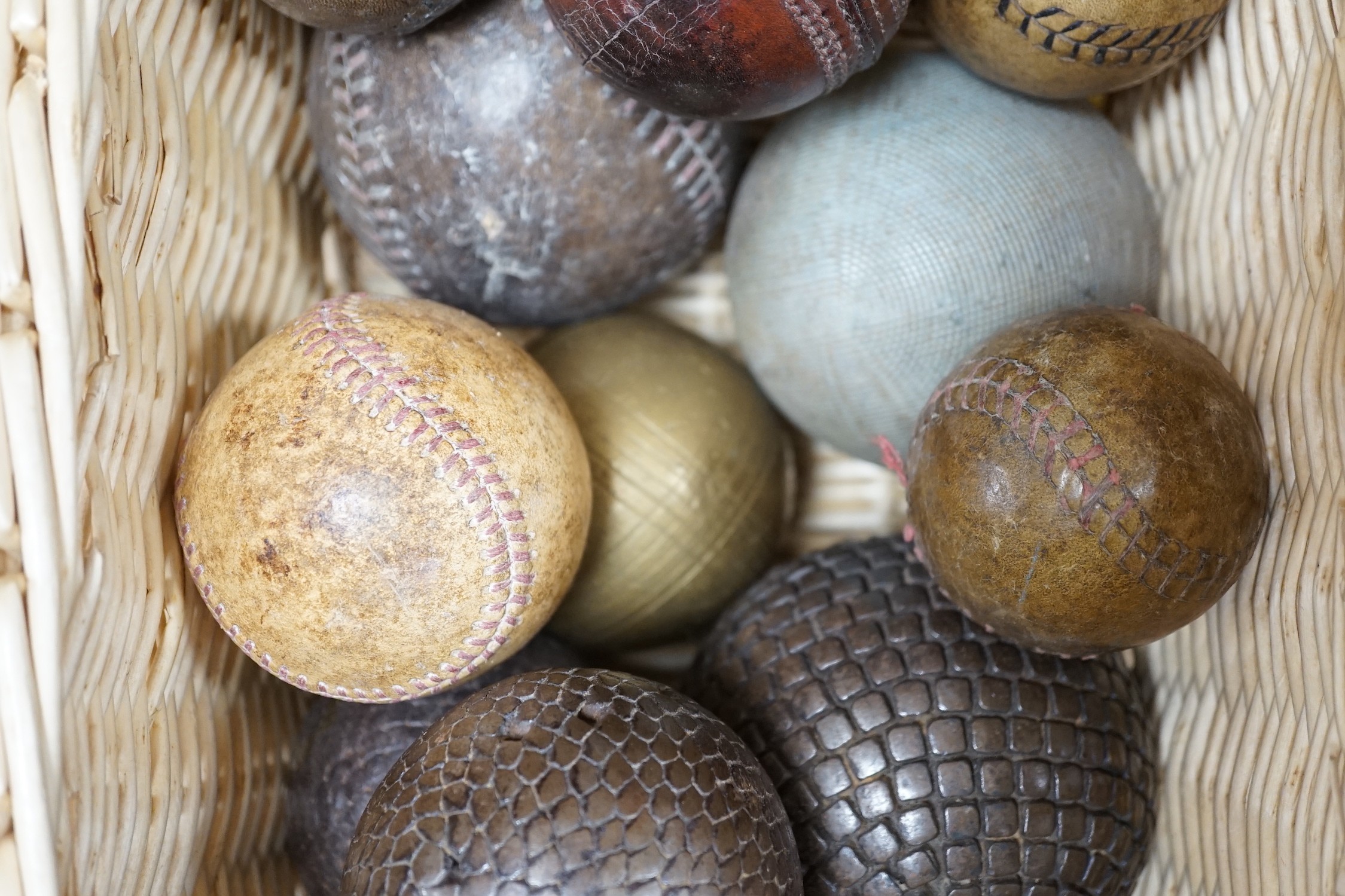 A collection of leather cricket and sporting balls